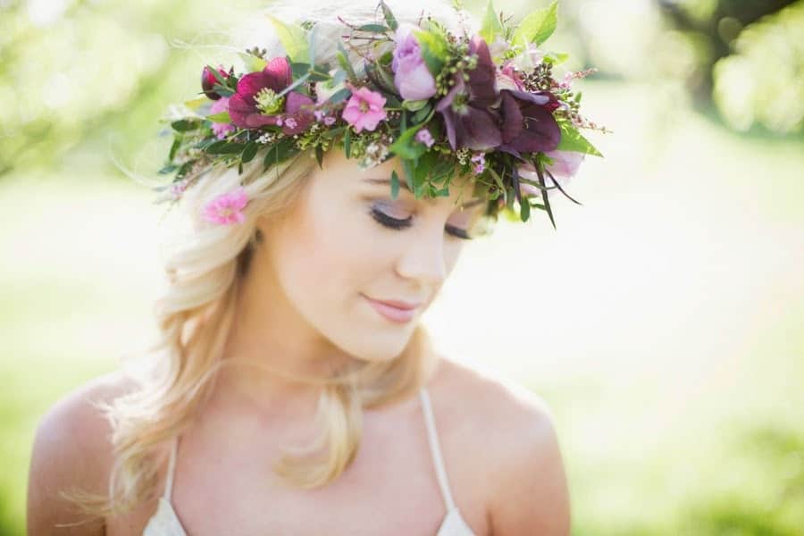 A bride wears a floral crown of lavender colored blooms