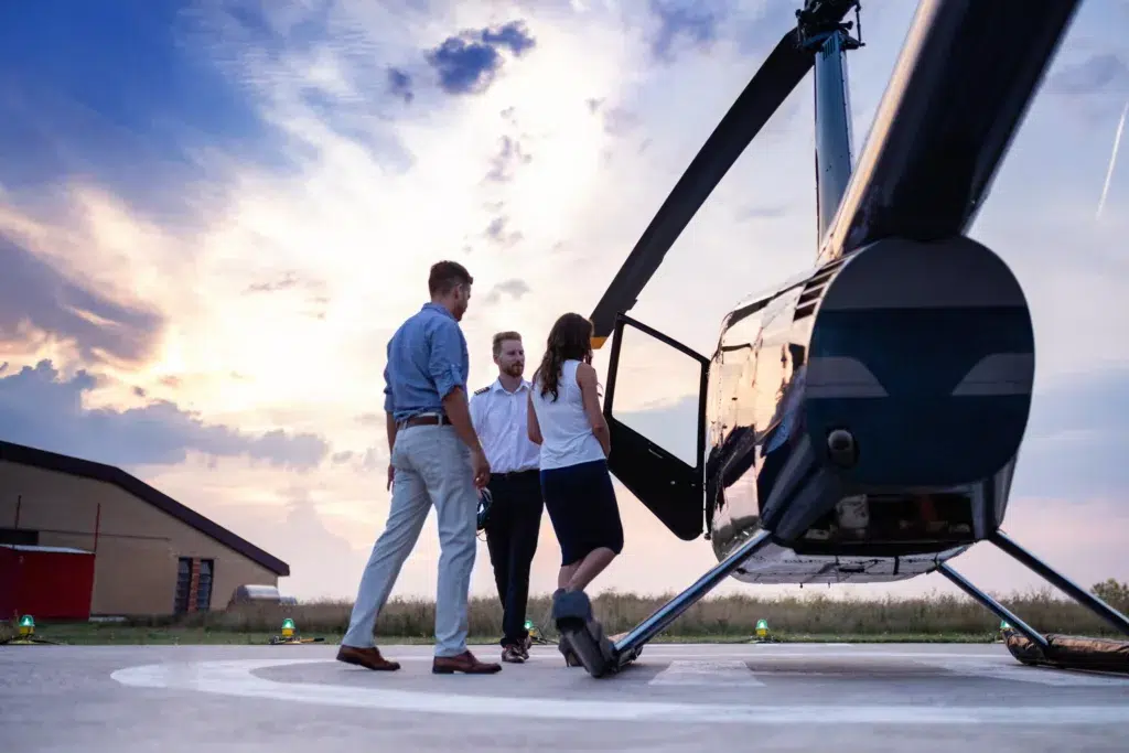 Chopper pilot reaching for handshake while greeting a couple