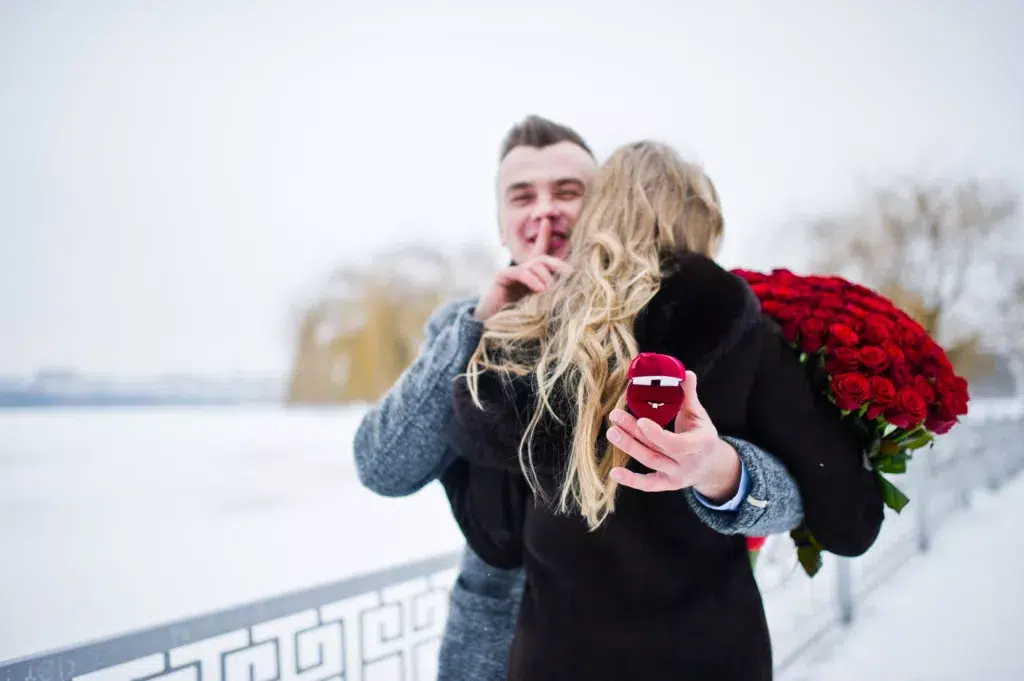 Man proposing on a snowy Valentine's Day