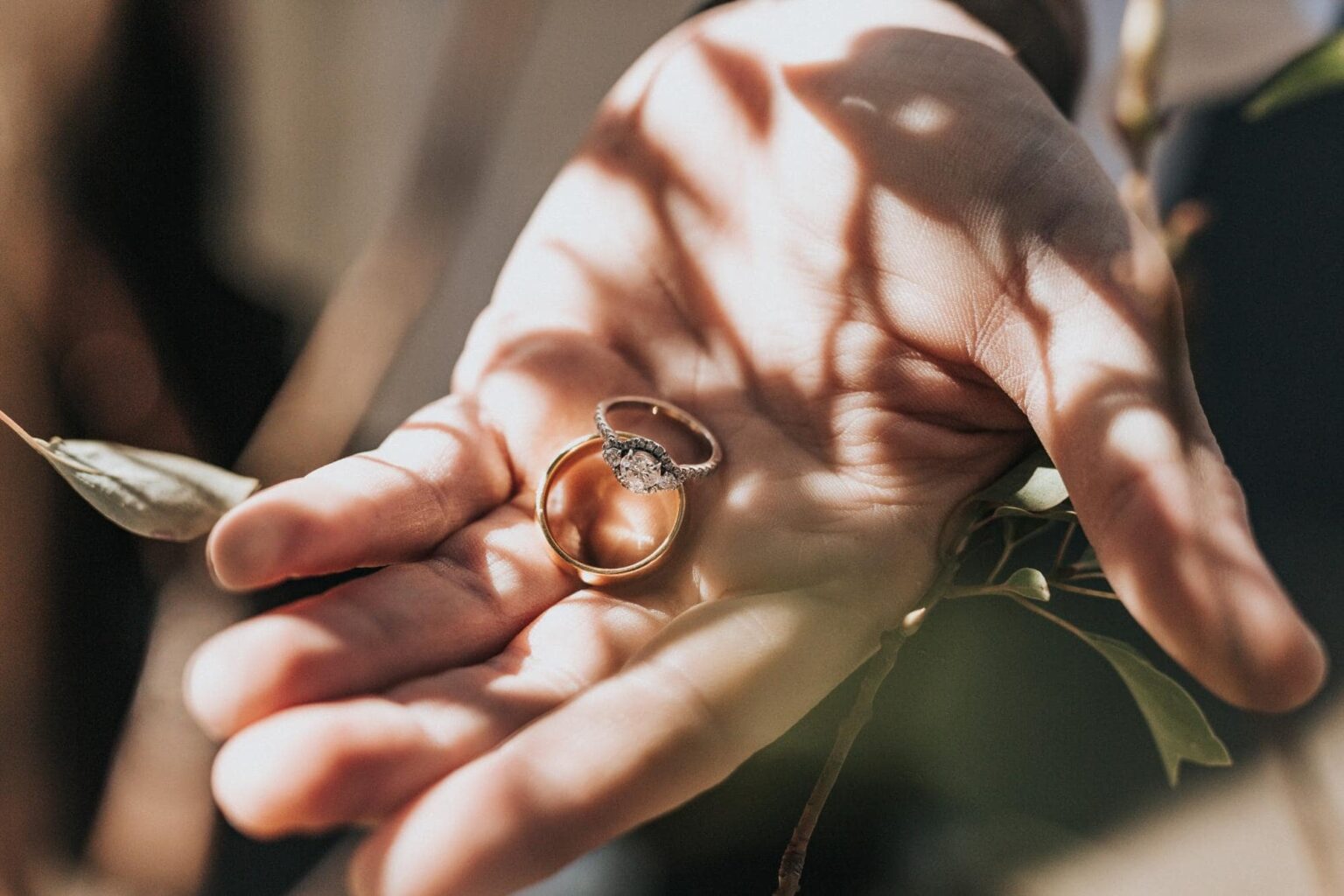 A three stone engagement ring in a bride's hand