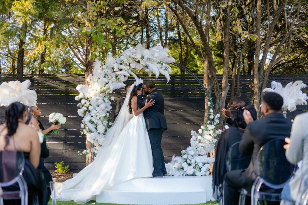 Bride and groom kissing newlyweds