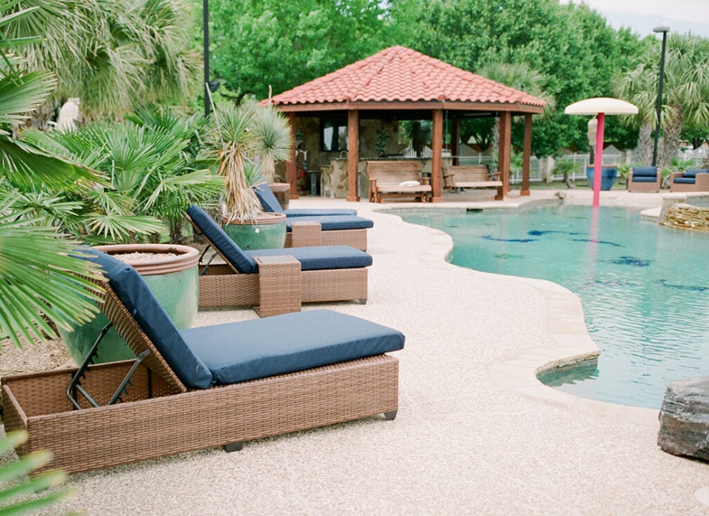 A pool with beautiful lounge chairs at the Dallas Oasis