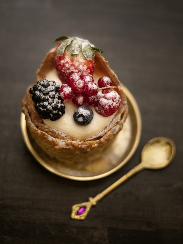 A lemon tart with fresh berries in the Dallas Oasis ballroom