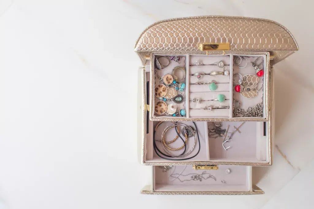 Luxurious travel jewelry case open on a white marble countertop