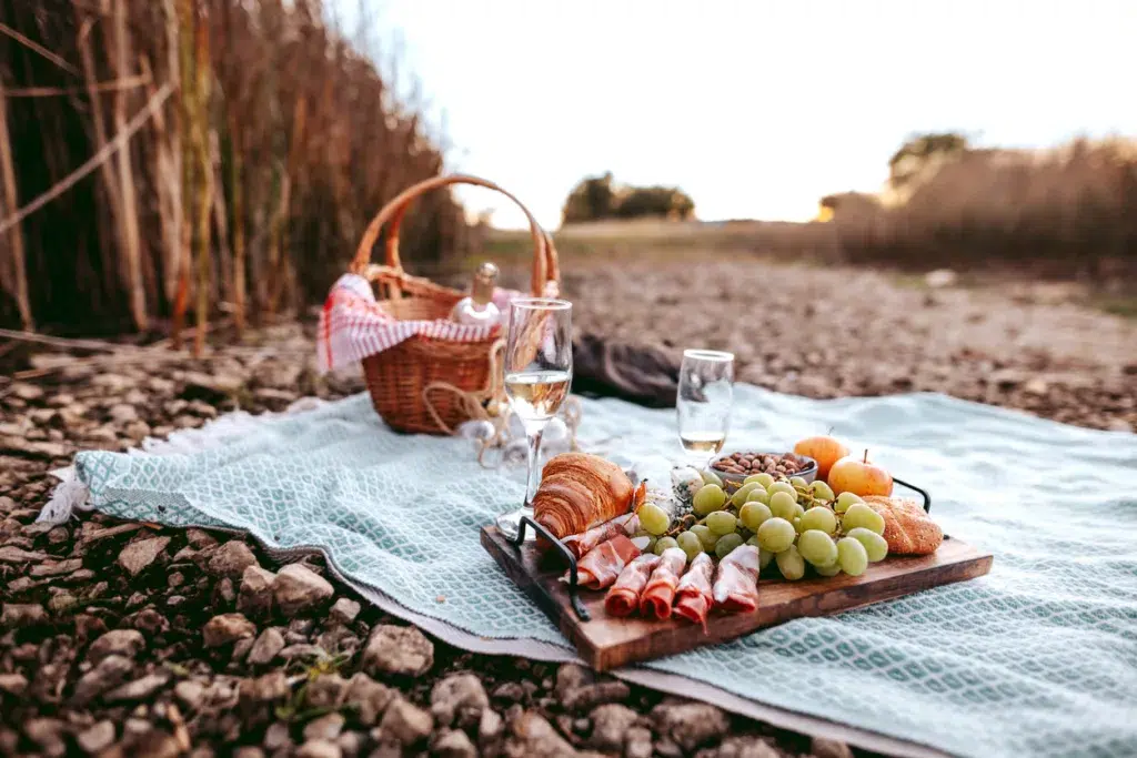 Romantic picnic setup atop a bridesmaid's gifted picnic blanket