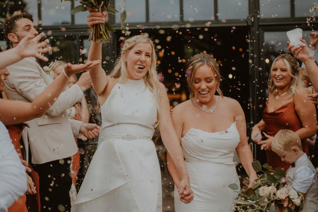 A bride makes her grand entrance at the wedding reception while listening to one of the best wedding songs from our list