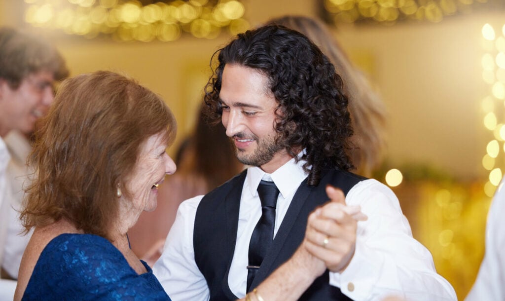 A mother and son dance to their chosen song at a wedding reception